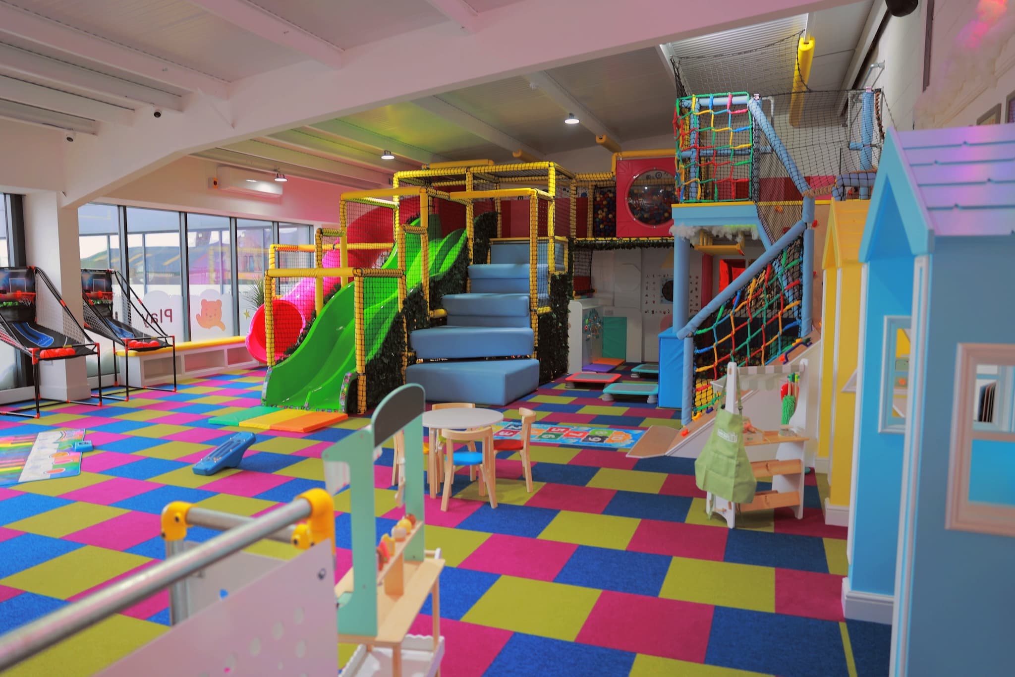 Children playing in a colourful indoor play cafe